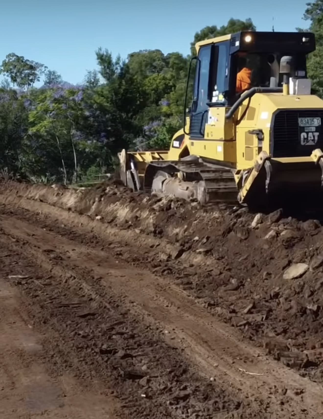 Yellow CAT dozer working a rural earth access track