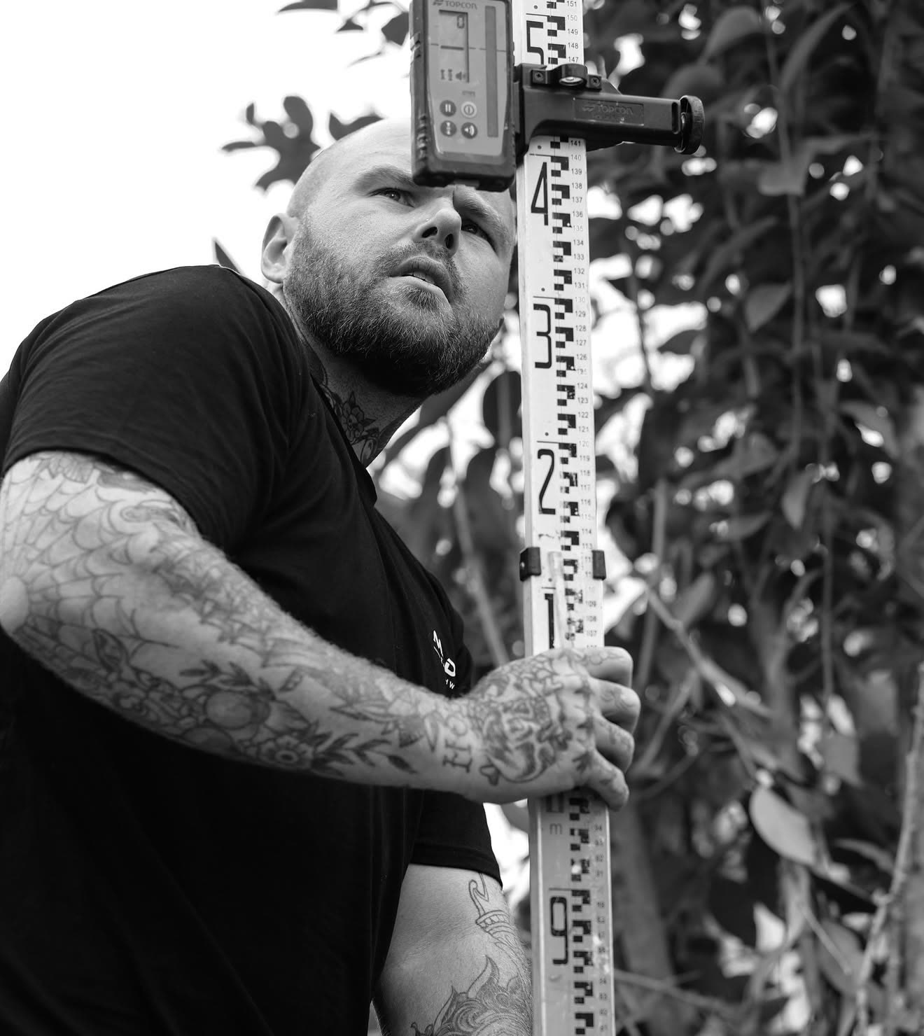 Jesse Madden holding a TOPCON survey staff, checking levels on a Hawkesbury site
