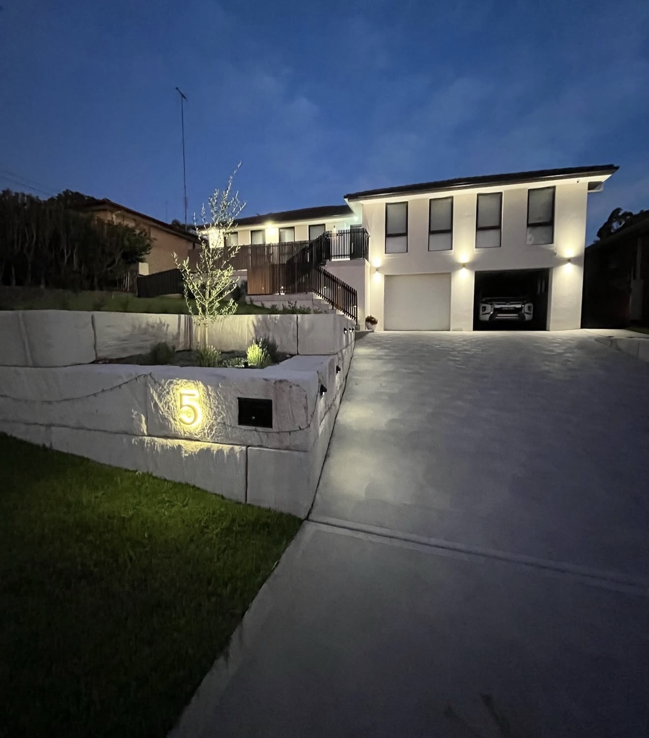 Sandstone retaining wall at night with illuminated house number - Hawkesbury NSW