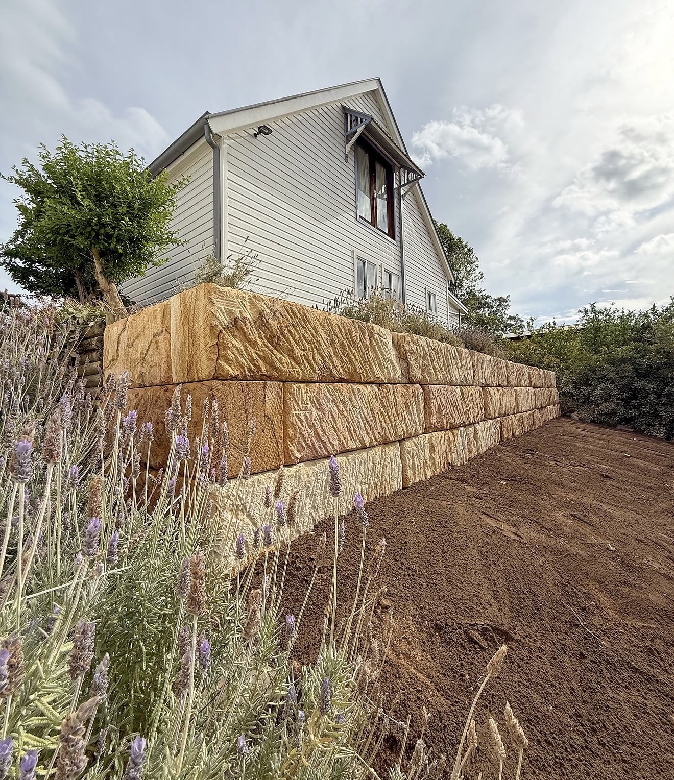 New sandstone block retaining wall replacing failed timber wall - Hawkesbury NSW