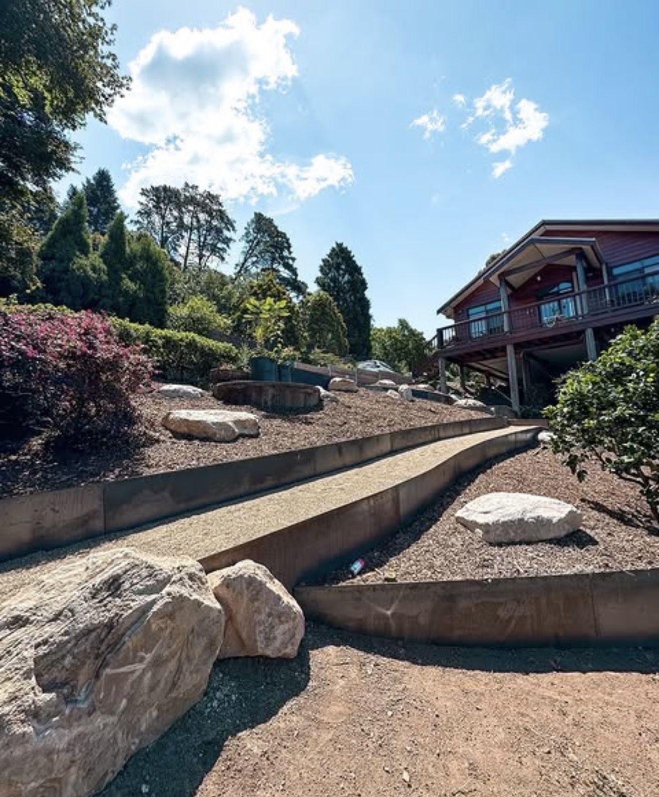 Hardwood sleeper retaining wall terraces with boulder landscaping - Hawkesbury NSW