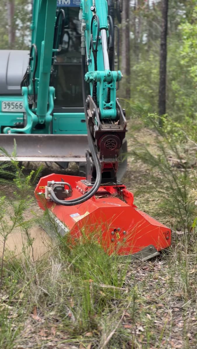 Forestry mulcher head mounted on Madden Earthworks excavator in bushland